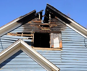 Fire damage to a home's gable end. Filing fire damage claims after a house fire.