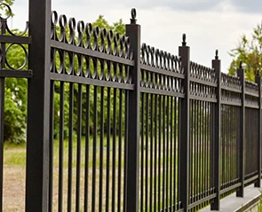 Black metal fence installation with decorative circles and spear-topped posts.